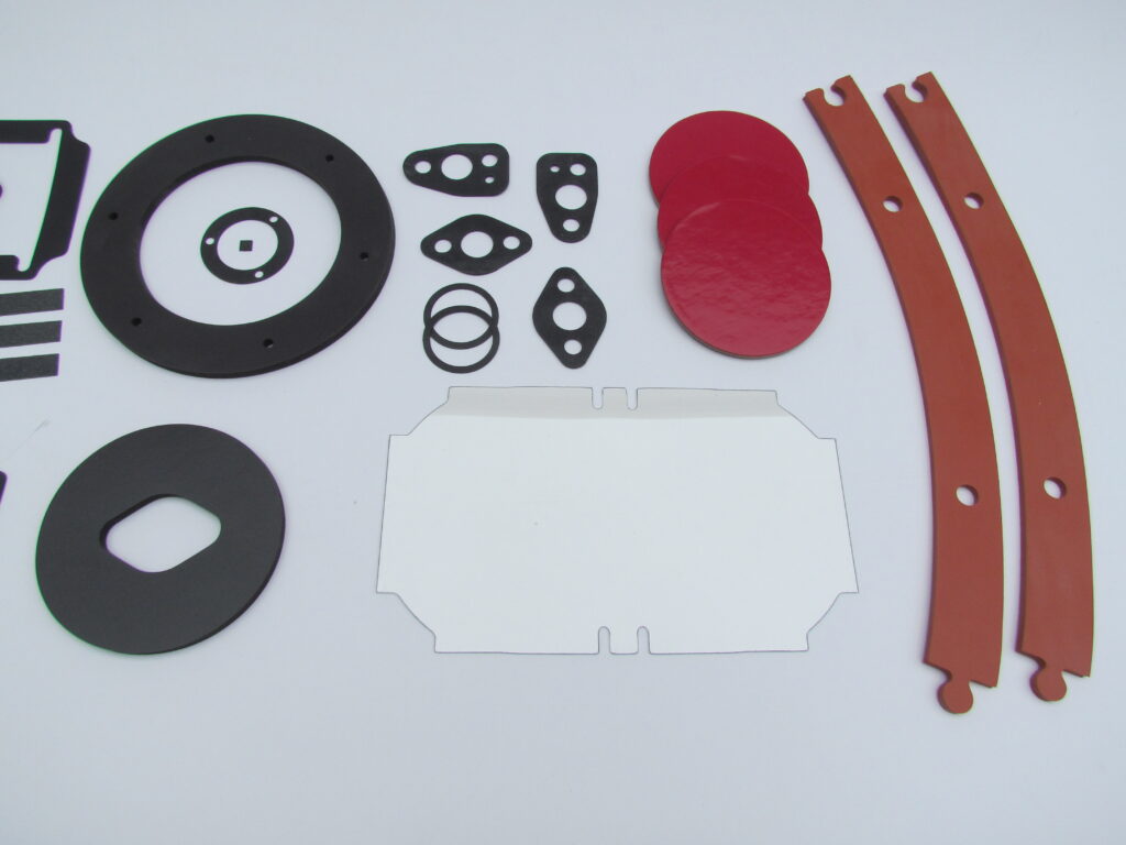Die-cut flange gaskets, ring gaskets, red silicone discs and rubber strips made by Mag-Knight
